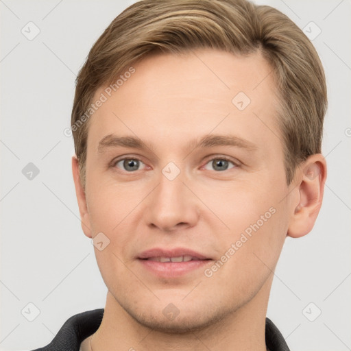 Joyful white young-adult male with short  brown hair and grey eyes