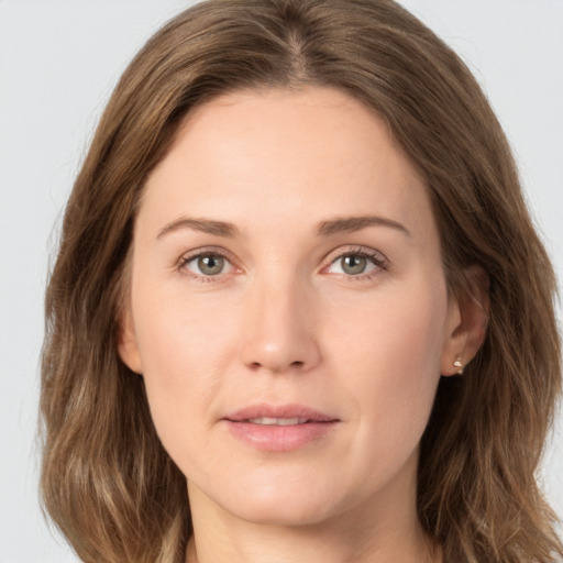 Joyful white young-adult female with long  brown hair and green eyes