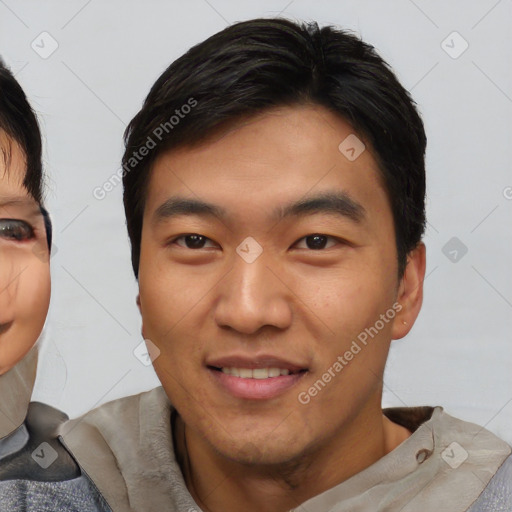 Joyful asian young-adult male with short  black hair and brown eyes