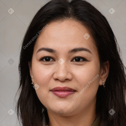 Joyful latino young-adult female with long  brown hair and brown eyes