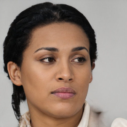 Joyful latino young-adult female with short  black hair and brown eyes