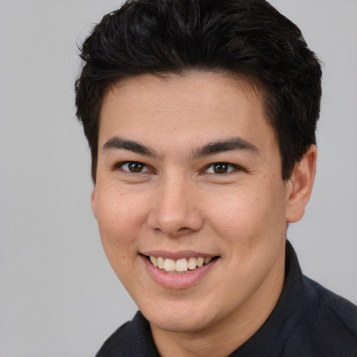 Joyful asian young-adult male with short  brown hair and brown eyes