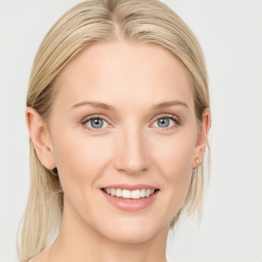 Joyful white young-adult female with medium  brown hair and blue eyes