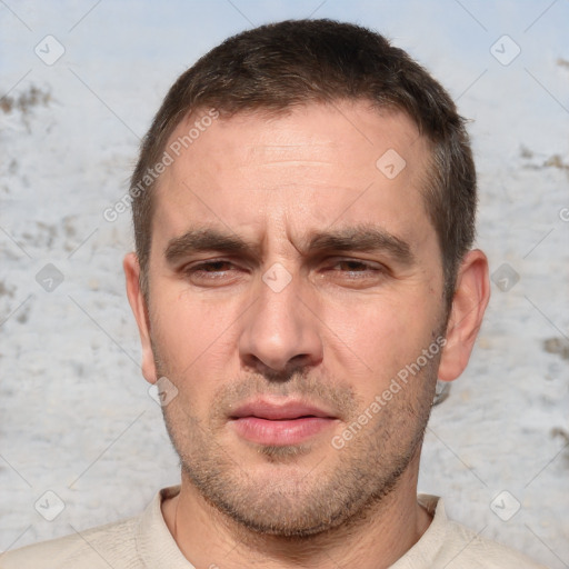 Joyful white adult male with short  brown hair and brown eyes