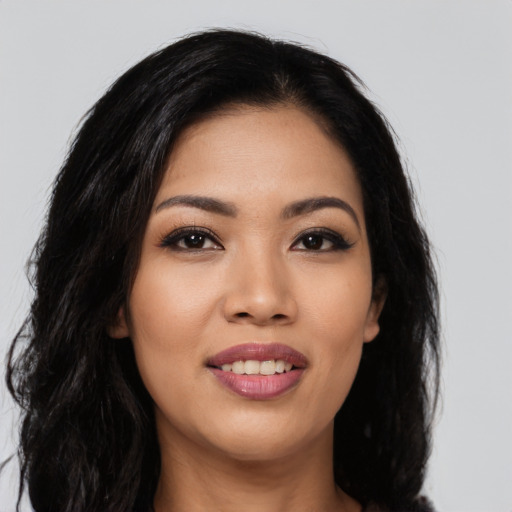 Joyful asian young-adult female with long  black hair and brown eyes