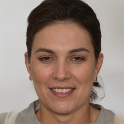 Joyful white adult female with short  brown hair and brown eyes