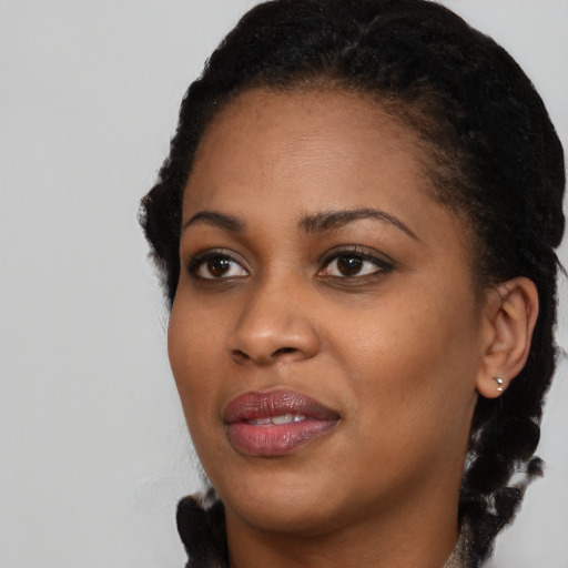 Joyful black young-adult female with medium  black hair and brown eyes