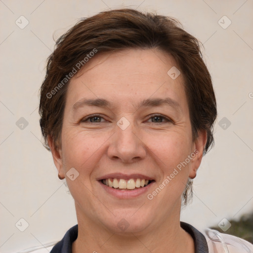 Joyful white adult female with short  brown hair and grey eyes