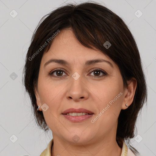 Joyful white adult female with medium  brown hair and brown eyes