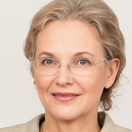 Joyful white adult female with medium  brown hair and blue eyes