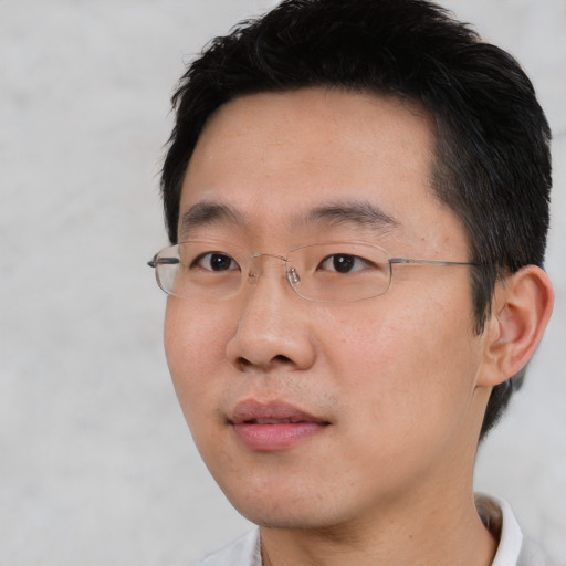 Neutral asian adult male with short  black hair and brown eyes
