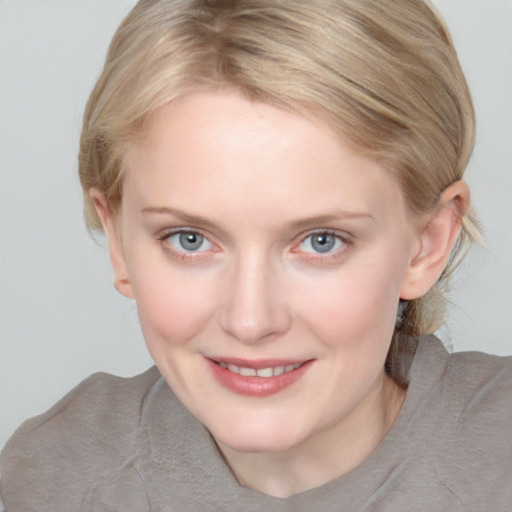 Joyful white young-adult female with medium  brown hair and blue eyes