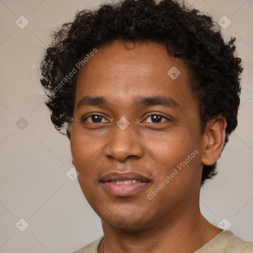 Joyful black young-adult male with short  brown hair and brown eyes