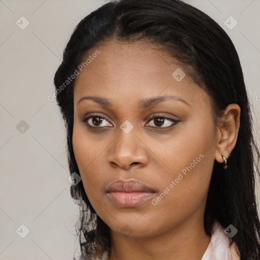 Joyful black young-adult female with long  brown hair and brown eyes