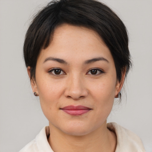 Joyful asian young-adult female with medium  brown hair and brown eyes