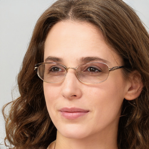 Joyful white adult female with long  brown hair and green eyes