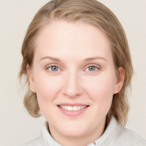 Joyful white young-adult female with medium  brown hair and blue eyes