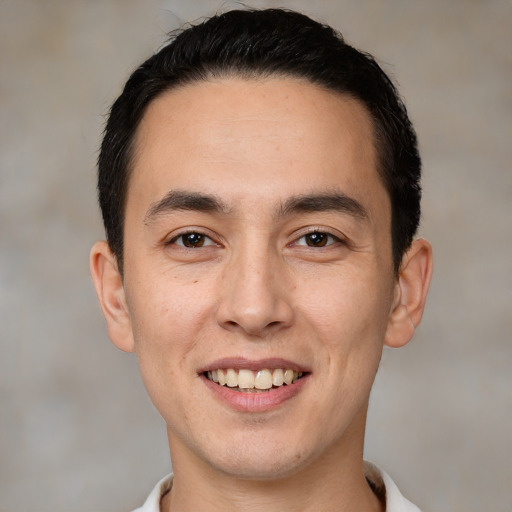 Joyful white young-adult male with short  black hair and brown eyes