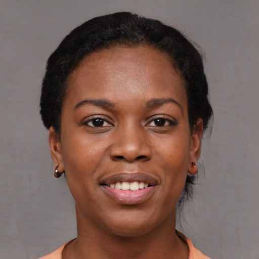 Joyful black young-adult female with short  brown hair and brown eyes