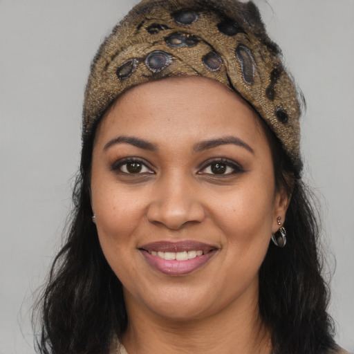 Joyful black young-adult female with long  brown hair and brown eyes