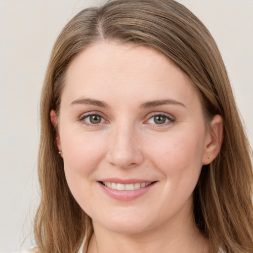 Joyful white young-adult female with long  brown hair and grey eyes