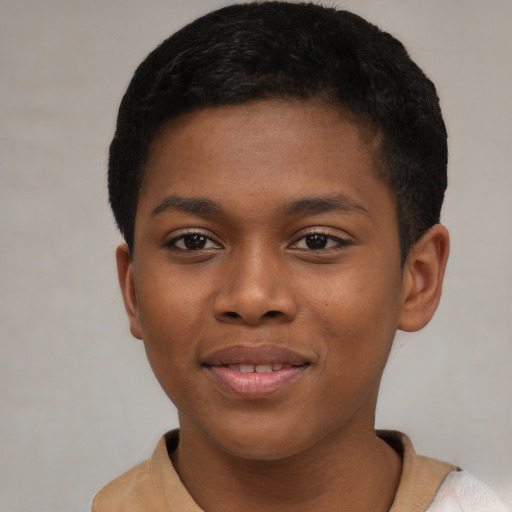 Joyful black child male with short  brown hair and brown eyes