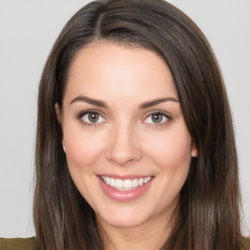 Joyful white young-adult female with long  brown hair and brown eyes