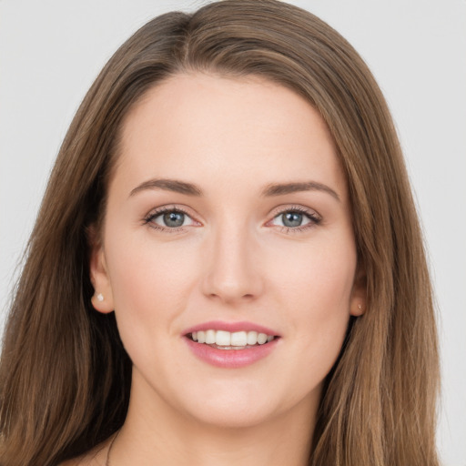 Joyful white young-adult female with long  brown hair and grey eyes