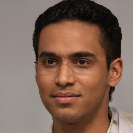 Joyful white young-adult male with short  black hair and brown eyes