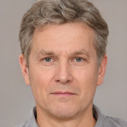 Joyful white adult male with short  brown hair and grey eyes