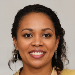 Joyful latino young-adult female with long  brown hair and brown eyes