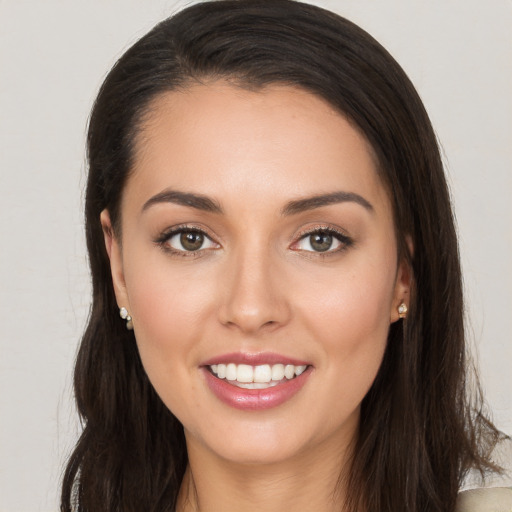 Joyful white young-adult female with long  brown hair and brown eyes