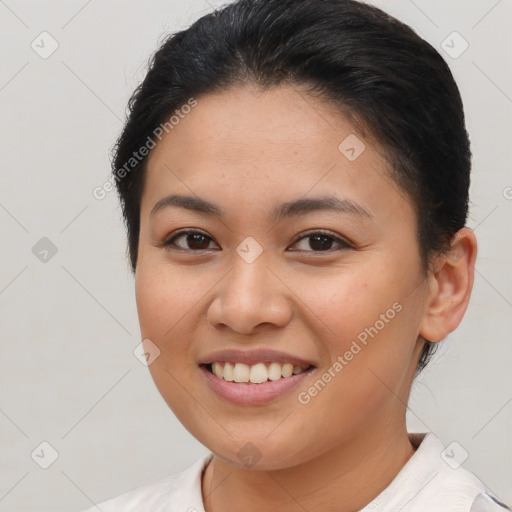 Joyful latino young-adult female with short  brown hair and brown eyes