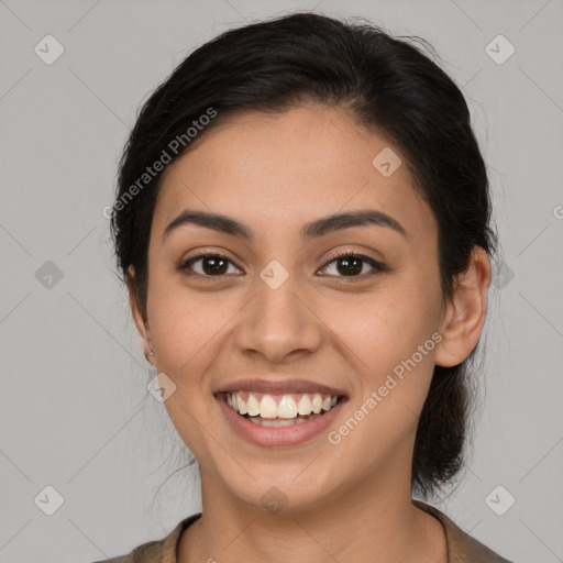 Joyful latino young-adult female with medium  brown hair and brown eyes