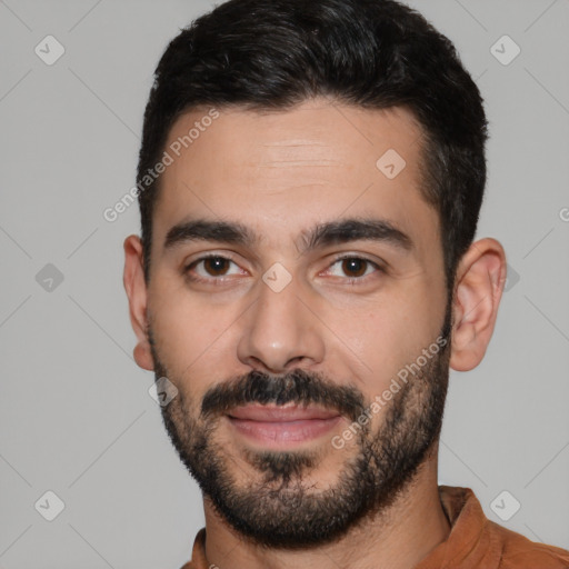 Joyful white young-adult male with short  black hair and brown eyes