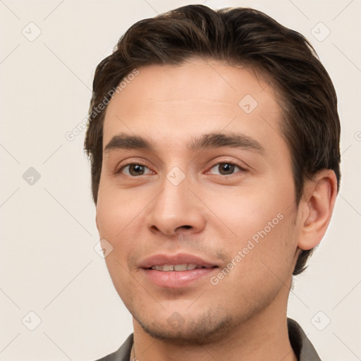 Joyful white young-adult male with short  brown hair and brown eyes