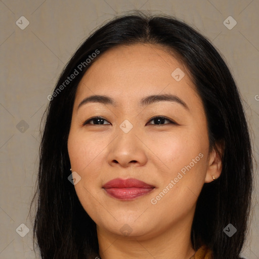 Joyful asian young-adult female with long  brown hair and brown eyes