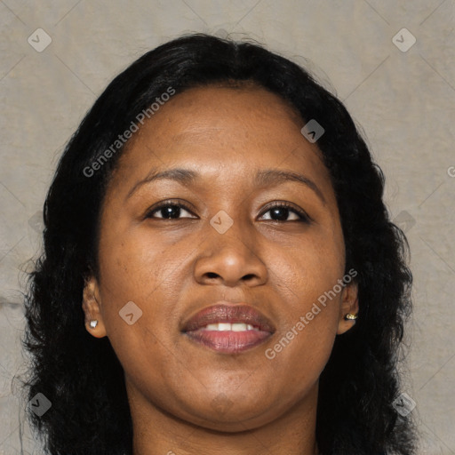 Joyful black adult female with long  brown hair and brown eyes