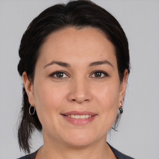 Joyful white adult female with medium  brown hair and brown eyes