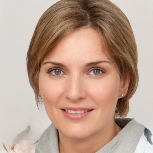 Joyful white young-adult female with medium  brown hair and blue eyes