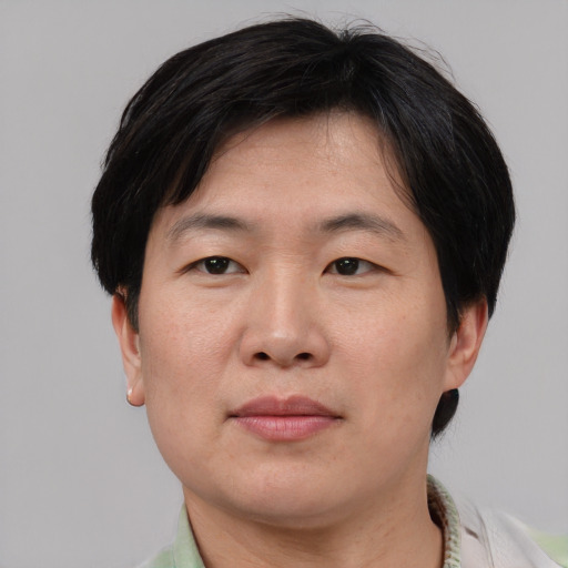 Neutral asian adult male with short  brown hair and brown eyes