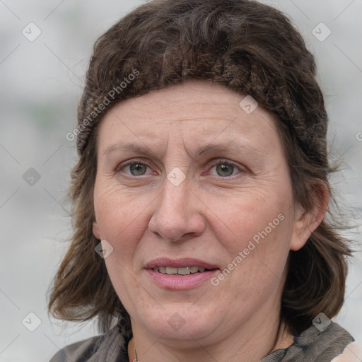 Joyful white adult female with medium  brown hair and blue eyes