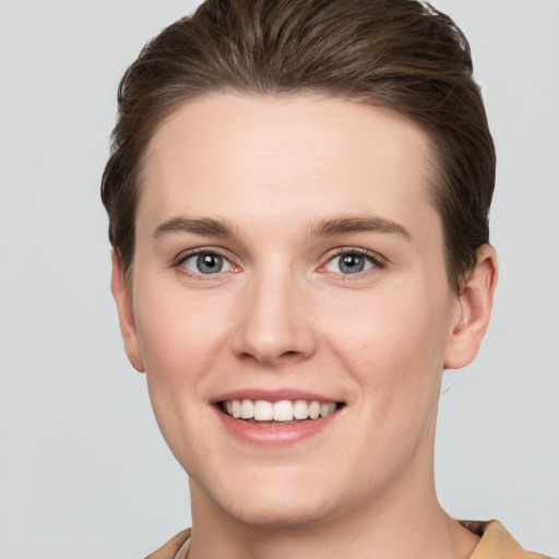 Joyful white young-adult female with short  brown hair and grey eyes