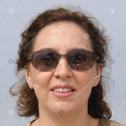 Joyful white adult female with medium  brown hair and blue eyes