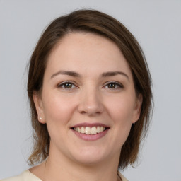 Joyful white young-adult female with medium  brown hair and brown eyes