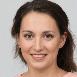 Joyful white young-adult female with medium  brown hair and brown eyes