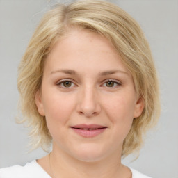 Joyful white young-adult female with medium  brown hair and blue eyes