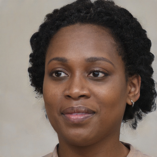 Joyful black young-adult female with medium  black hair and brown eyes