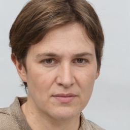 Joyful white adult female with short  brown hair and grey eyes