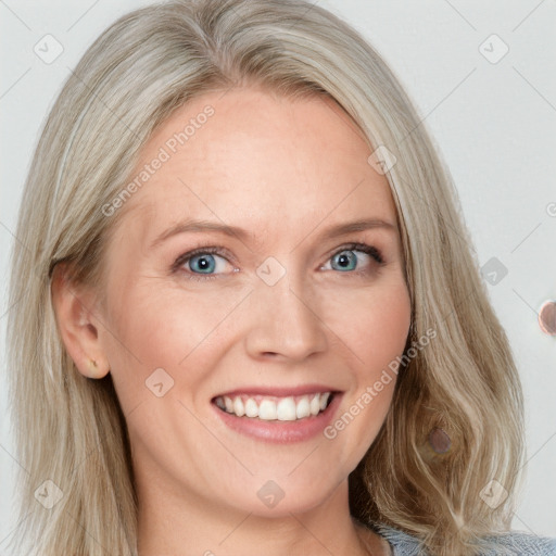 Joyful white adult female with medium  blond hair and blue eyes